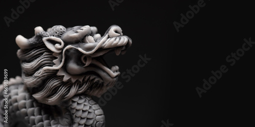 Gray dragon statue on a black background. The symbol of 2024. Happy Chinese New Year.