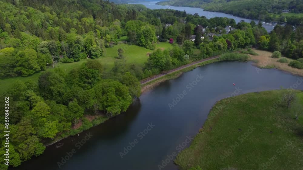 Aerial drone video 4K of beautiful green summer landscape of a lake, forest and mountains in the background - taken at Windermere, Lake District. UK Aerial drone video 4K of beautiful green summer landscape of a lake, forest and mountains in the background - taken at Windermere, Lake District. UK