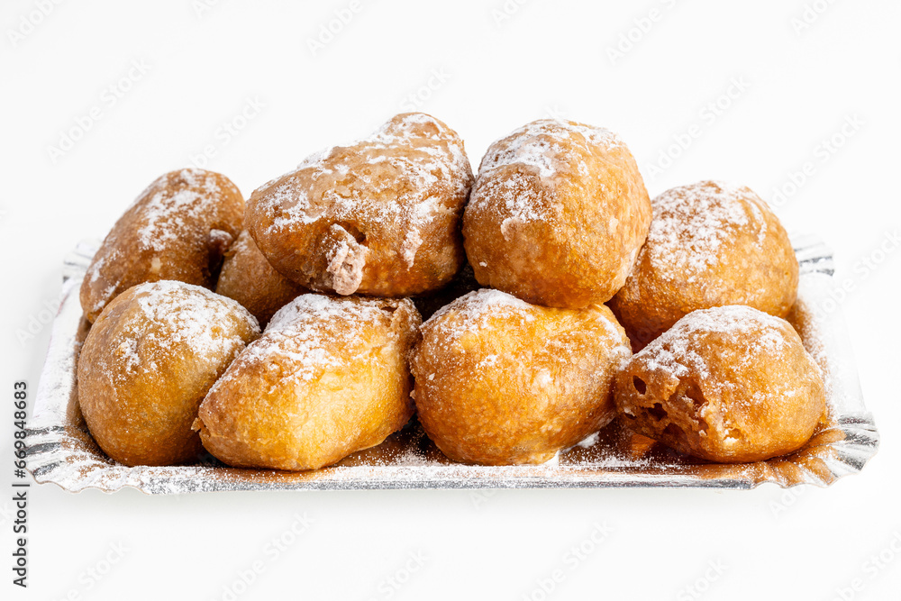 Plate of buñuelos de viento with cream and truffle typical dessert of the day of the saints in Spain