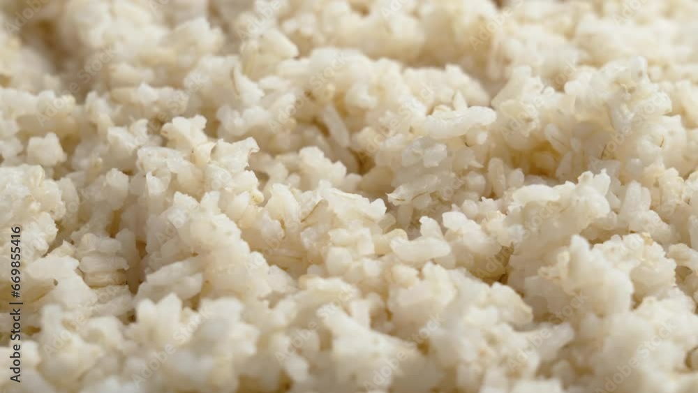 Freshly cooked rice texture close up. Asian traditional food. Rotation Freshly cooked rice texture close up. Asian traditional food. Rotation