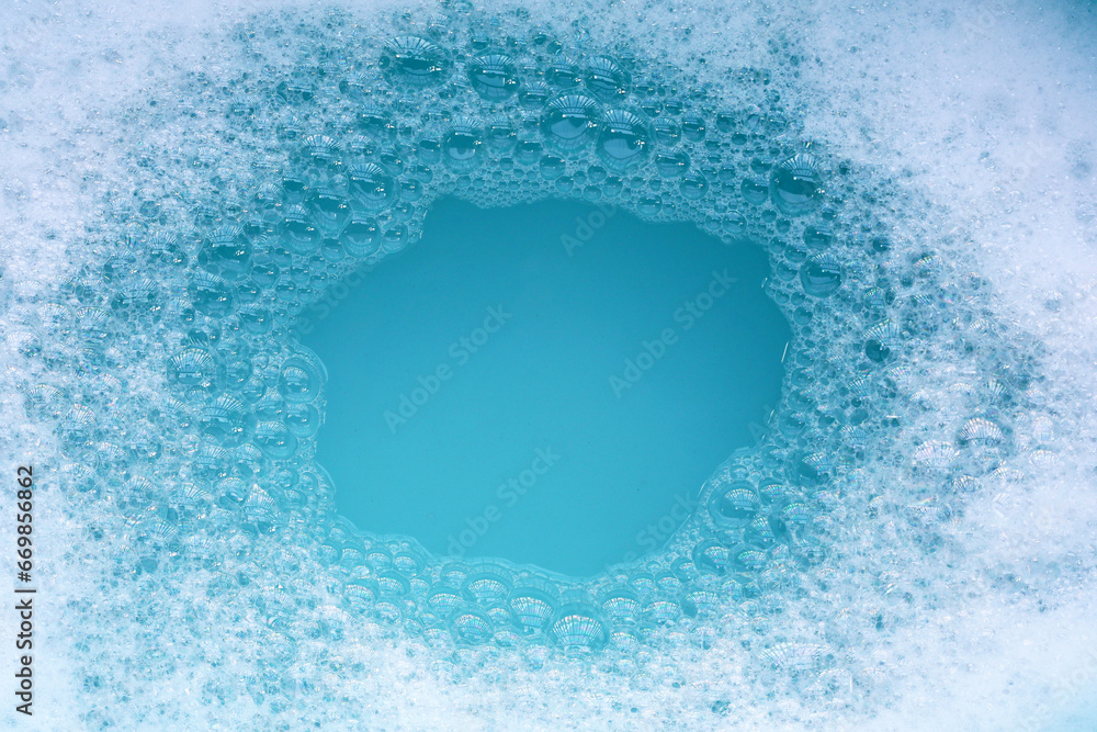 Detergent foam bubble on water. Blue background, Soap sud - obrazy, fototapety, plakaty 