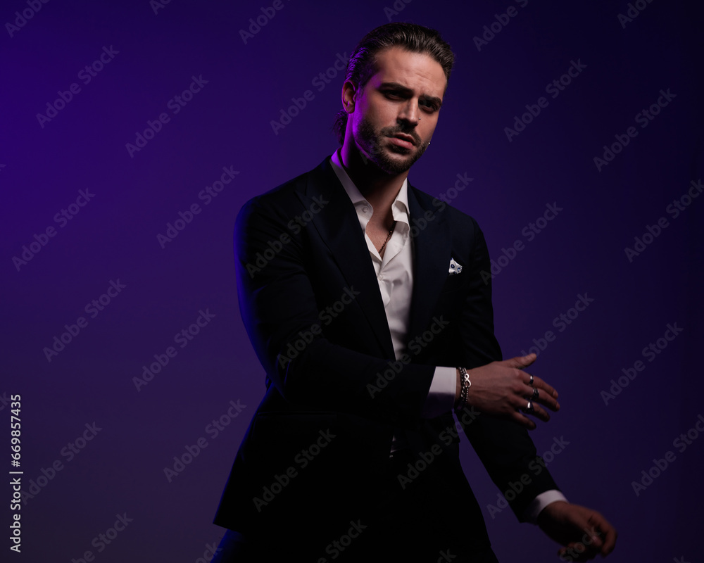elegant high class businessman with open collar shirt holding arms in fashion pose elegant high class businessman with open collar shirt holding arms in fashion pose