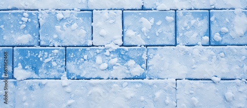 White snow covers a blue tile giving it a textured appearance