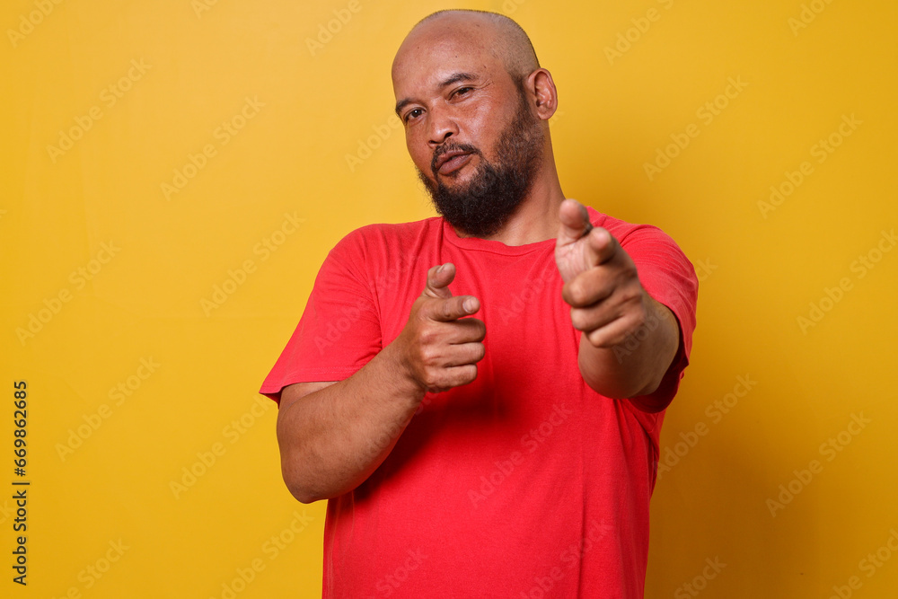 Bearded bald man pointing fingers to camera Bearded bald man pointing fingers to camera