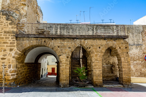 Tunnel view entrances, next to old castle with thick brick wall, Andalusia, Southern Spain, sunny day travel photograph