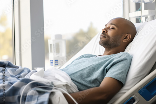 male cancer patients laying down on bed at hospital.