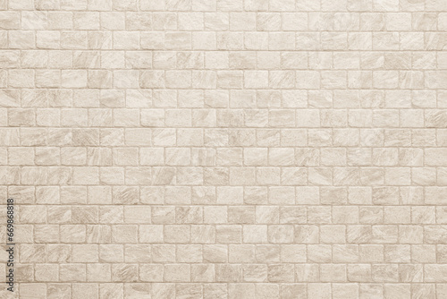 Empty background of wide cream brick wall texture. Beige old brown brick wall concrete or stone textured  wallpaper limestone abstract flooring. Grid uneven interior rock. Home decor design backdrop.