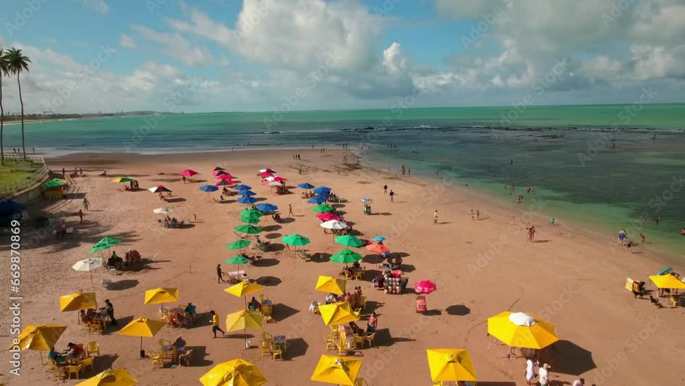 Aerial Forward Shot Of People With Parasols At Beach Against Cloudy Sky - Ipojuca, Brazil Aerial Forward Shot Of People With Parasols At Beach Against Cloudy Sky - Ipojuca, Brazil