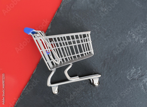shopping cart on red and black background with copy space.