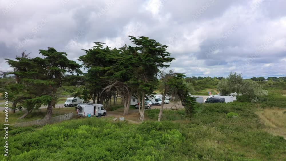 Drone shot, drone flight over a camper van pitch in the dunes on the Atlantic Ocean, Locmaraqer beach, Morbihan department, Brittany, France, Europe Drone shot, drone flight over a camper van pitch in the dunes on the Atlantic Ocean, Locmaraqer beach, Morbihan department, Brittany, France, Europe