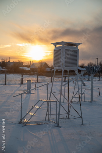 Weather station in the evening during sunset in winter. A device at a weather station for recording the weather close-up.