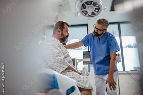Supportive doctor soothing a worried overweight patient, discussing test result in emergency room. Illnesses and diseases in middle-aged men's health. Compassionate physician supporting stressed photo