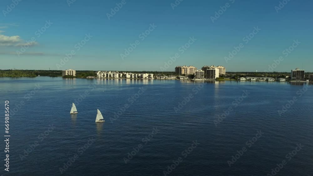 Aerial pan view of small sailboaters Aerial pan view of small sailboaters