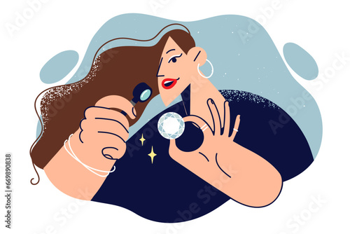 Woman examines diamond through magnifying glass, checking gemstone for authenticity or defectiveness