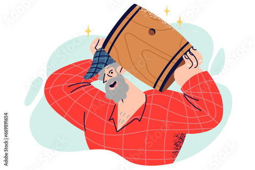 Elderly man lifts wooden barrel of bee honey or wine and with smile looks at screen.