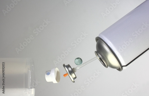 Aerosol can showing all the component parts that make an aerosol operate