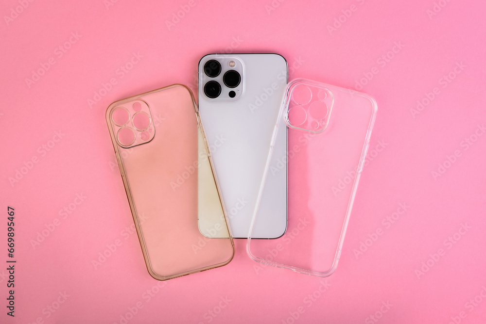 New and dirty silicone transparent phone cases and smartphone on pink background - obrazy, fototapety, plakaty 