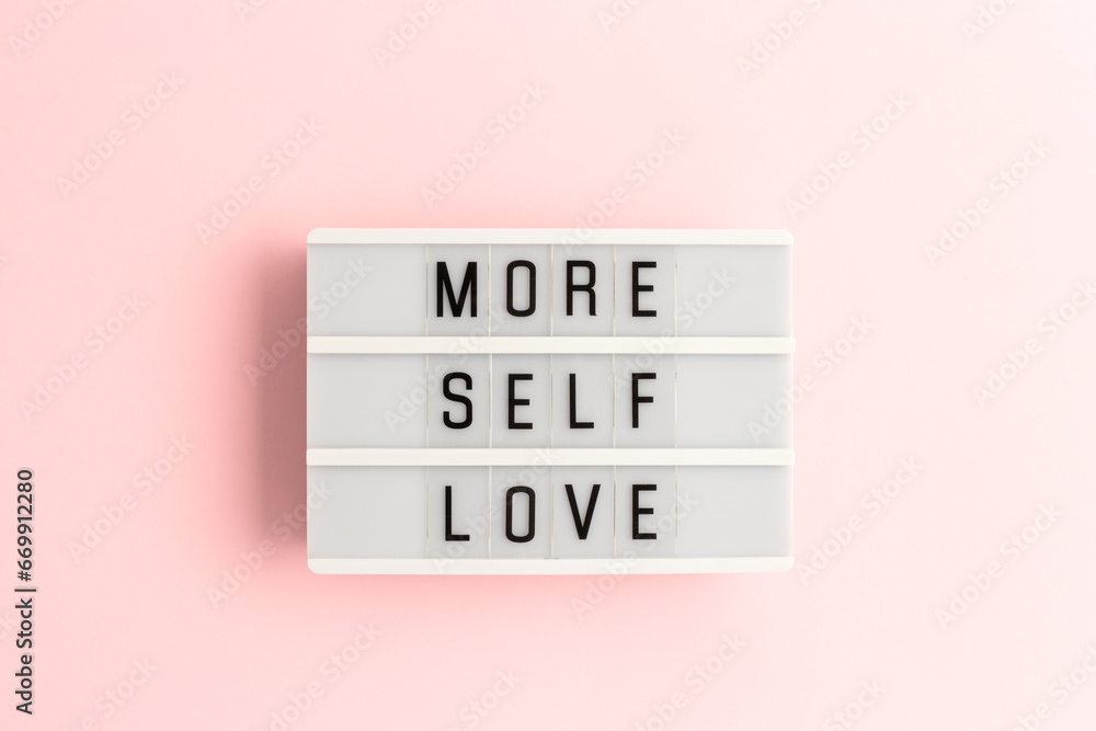 More self love. White lightbox with letters on a pink background. - obrazy, fototapety, plakaty 