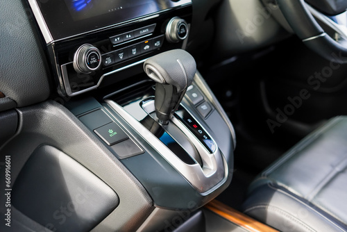 automatic transmission shift selector in the car interior. Closeup a manual shift of modern car gear shifter. 4x4 gear shift © Muanpare