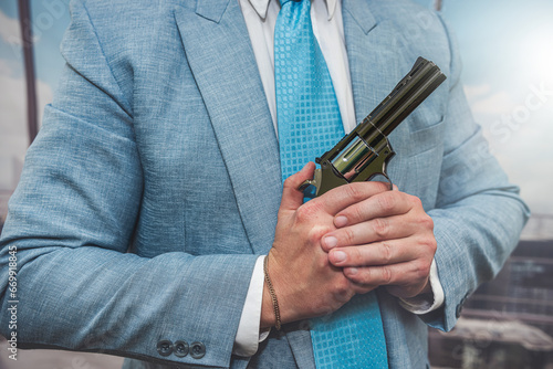 closeup agent in blue suit holding semi-automatic pistol gun