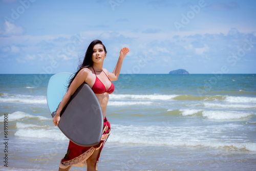 Canvas Print Asian woman surfer in sexi bikini holding surfboard playing on tropical beach at summer enjoy outdoor activity lifestyle water sport extreme surfing on travel vacation concept