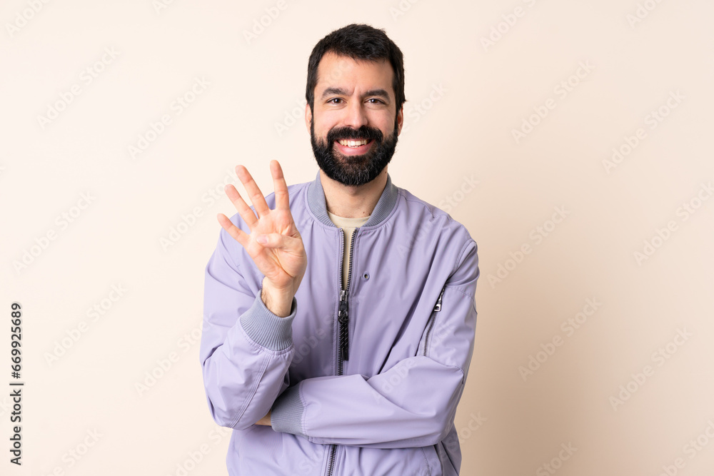 Caucasian man with beard wearing a jacket over isolated background happy and counting four with fingers Caucasian man with beard wearing a jacket over isolated background happy and counting four with fingers