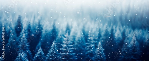 abstract blue winter snowfall forest background with blured snowy trees , winter and christmas concept, copy space for text, banner card wallpaper