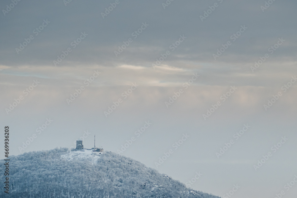 Fototapeta premium Medieval castle on top of a mountain in winter