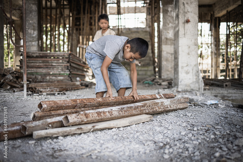 Poor children forced to do construction work, child labor, abuse To the rights of children, victims of human trafficking, World Day Against Child Labor. © Tinnakorn