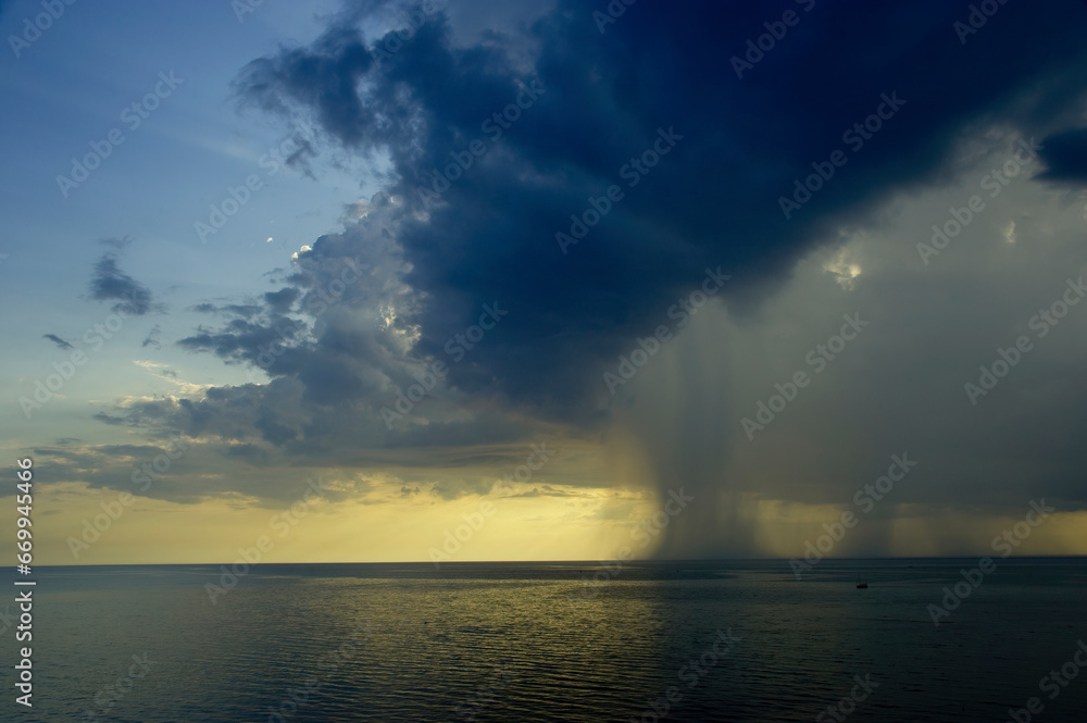 Rain in the sea at sunset