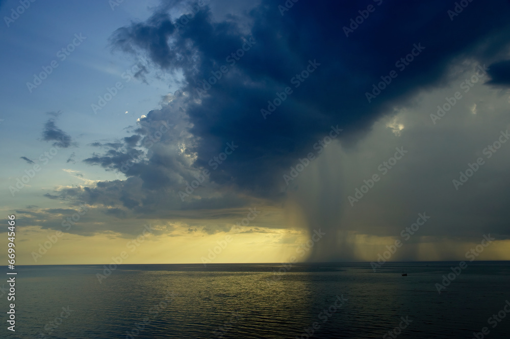 Rain in the sea at sunset Rain in the sea at sunset