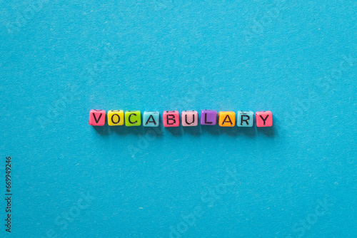 Canvastavla vocabulary word, learn language concept with multicolored letters on blue