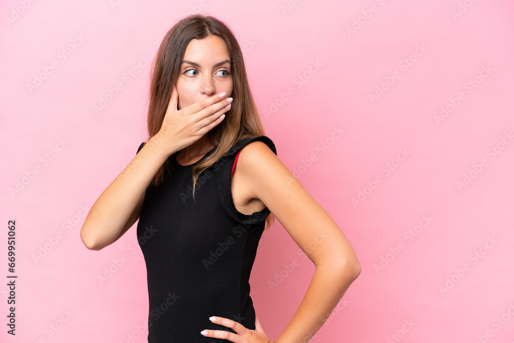 Young caucasian woman isolated on pink background doing surprise gesture while looking to the side Young caucasian woman isolated on pink background doing surprise gesture while looking to the side