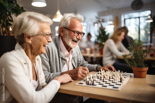 A group of old people pensioners play board games for the development of intelligence and spend interesting time in a house for the elderly Fototapet