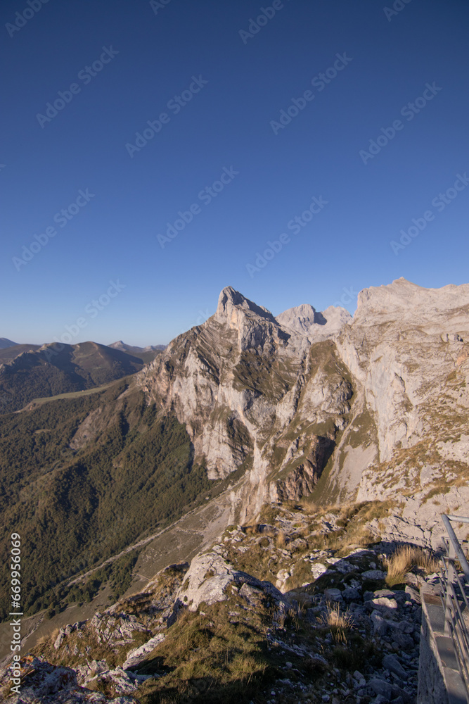 vertical photo, mountain landscape with vegetation, clear blue sky