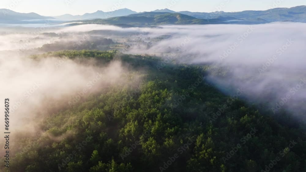 Aerial flight over the morning mist of Lika, Croatia. Flight over beautiful landscape with forest and grassland. Aerial flight over the morning mist of Lika, Croatia. Flight over beautiful landscape with forest and grassland.