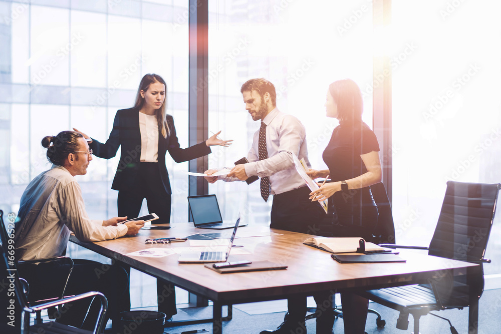 Full length view of business people collaborating around table Full length view of business people collaborating around table