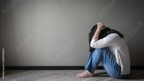 Panic attack, anxiety disorder menopause woman, stressful depressed person with mental health illness, headache and migraine sitting with back against wall on the floor in domestic home