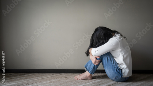 Anxiety disorder menopause woman, stressful depressed, panic attack person with mental health illness, headache and migraine sitting with back against wall on the floor in domestic home photo