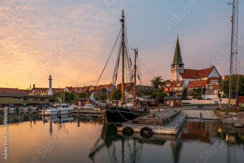 Denmark, Bornholm, Ronne, Sailing ship moored in harbor at dusk