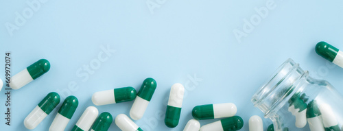 Foto Taking medicine design concept, top view of capsule pills on blue table background