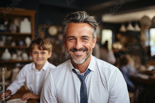 Portrait of an adult teacher for college students a man in a shirt looks at the camera beard and stylish hairstyle