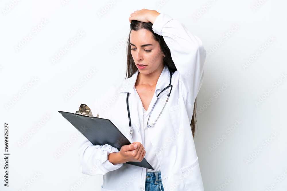 Young caucasian woman isolated on white background wearing a doctor gown and holding a folder Young caucasian woman isolated on white background wearing a doctor gown and holding a folder