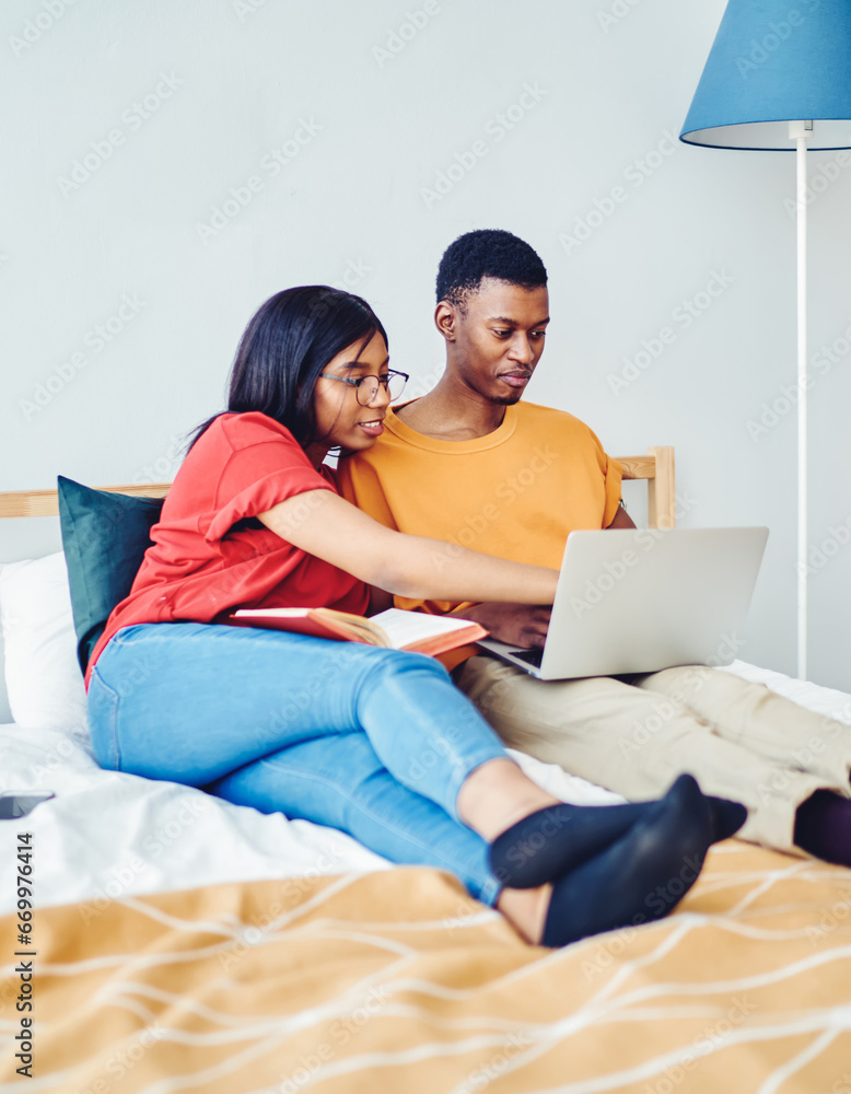 couple browse web page on netbook making booking together at home couple browse web page on netbook making booking together at home