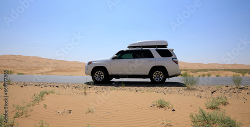Inner Mongolia ,China - July 24 2021: Driving White 2020 Toyota 4Runner TRD crossing in the desert road trip