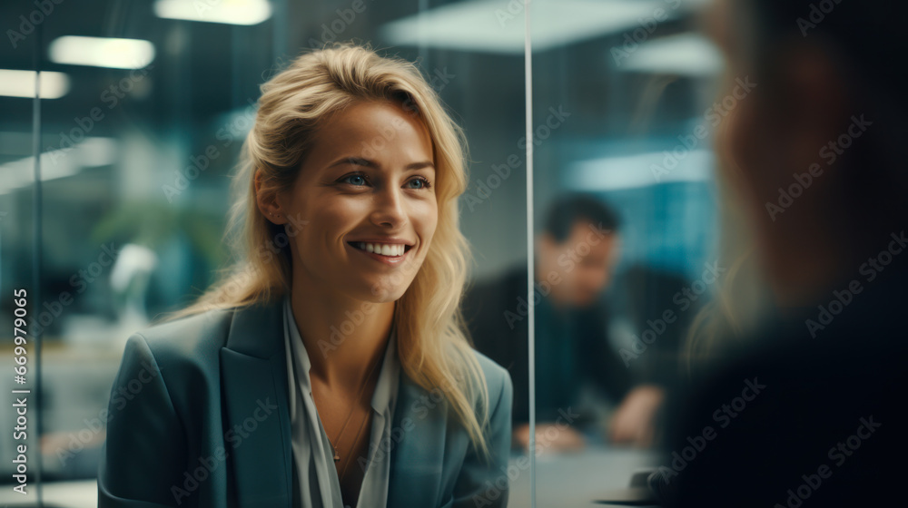 A beautiful woman is having a conversation in the office at a meeting. A woman of Scandinavian appearance works in an office, at a meeting. Concept of work, communication. A beautiful woman is having a conversation in the office at a meeting. A woman of Scandinavian appearance works in an office, at a meeting. Concept of work, communication.