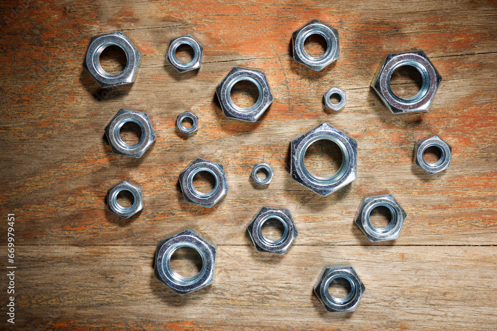 Metal nuts group on a wood table Metal nuts group on a wood table