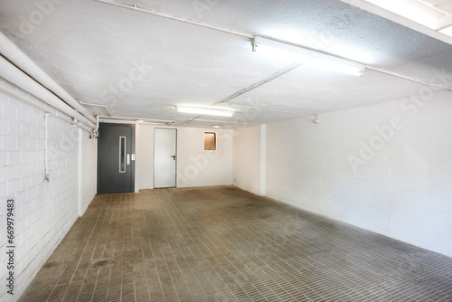 Private parking place interior. Residential garage indoor with lift. Basement