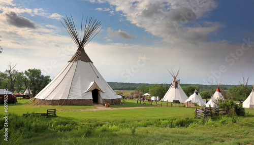 view of an indian native american village with teepee tents © Nichole
