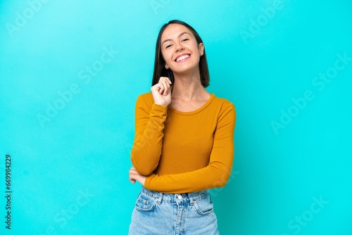 Young caucasian woman isolated on blue background laughing